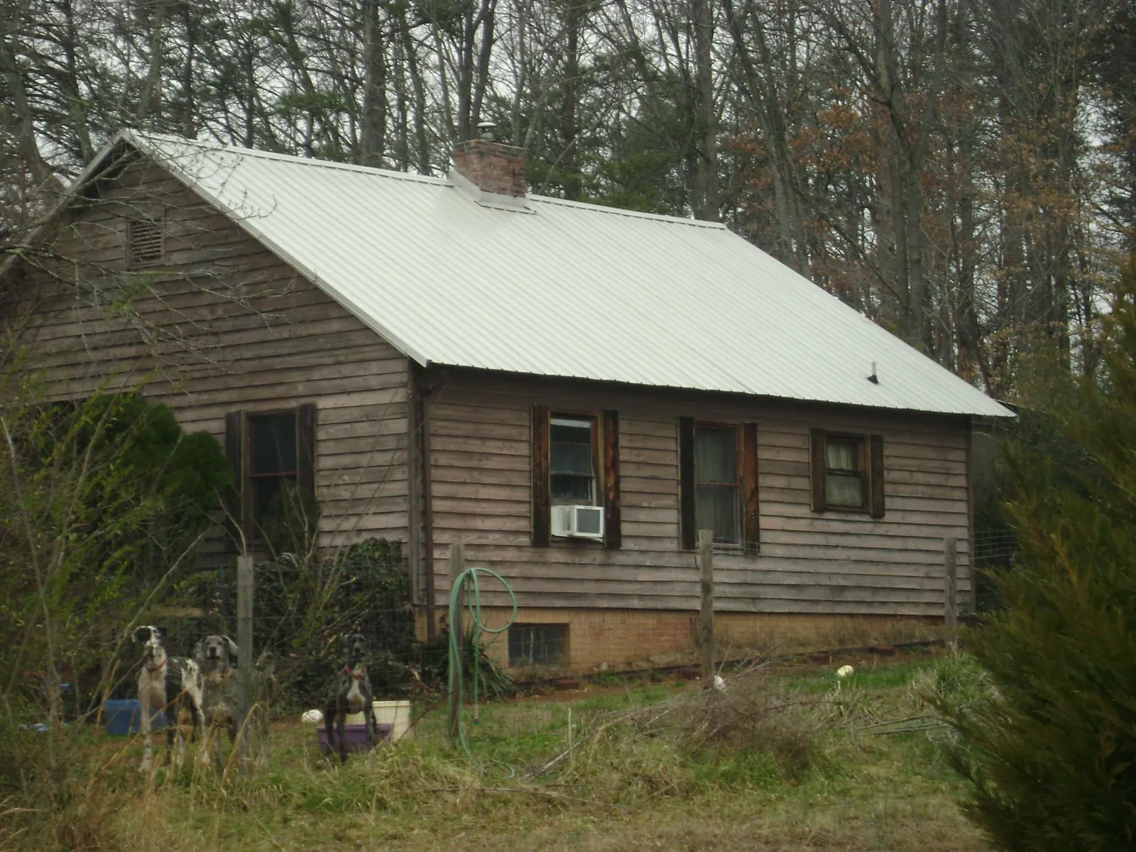 White metal roof on an old wood sided farmhouse, from a Metal Roof Installation job in Imbler